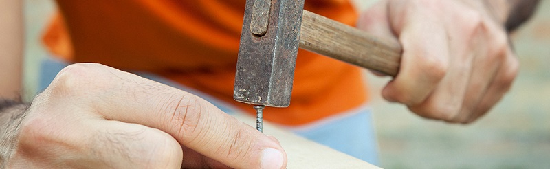Nail being hammered into wood