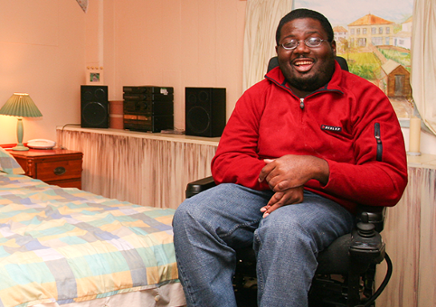 Man in wheelchair in bedroom