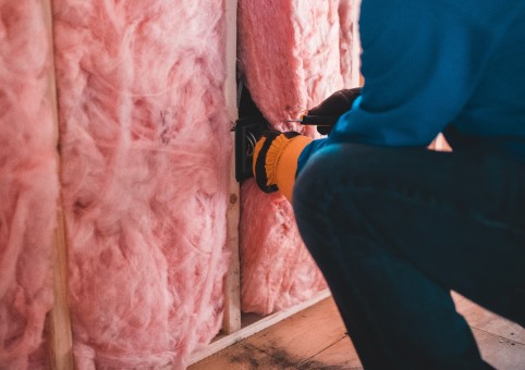 Person installing insulation