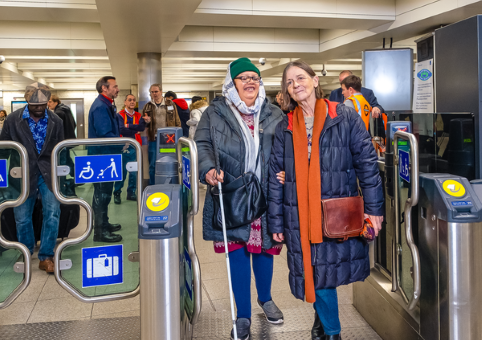 Blind woman being helped at train station