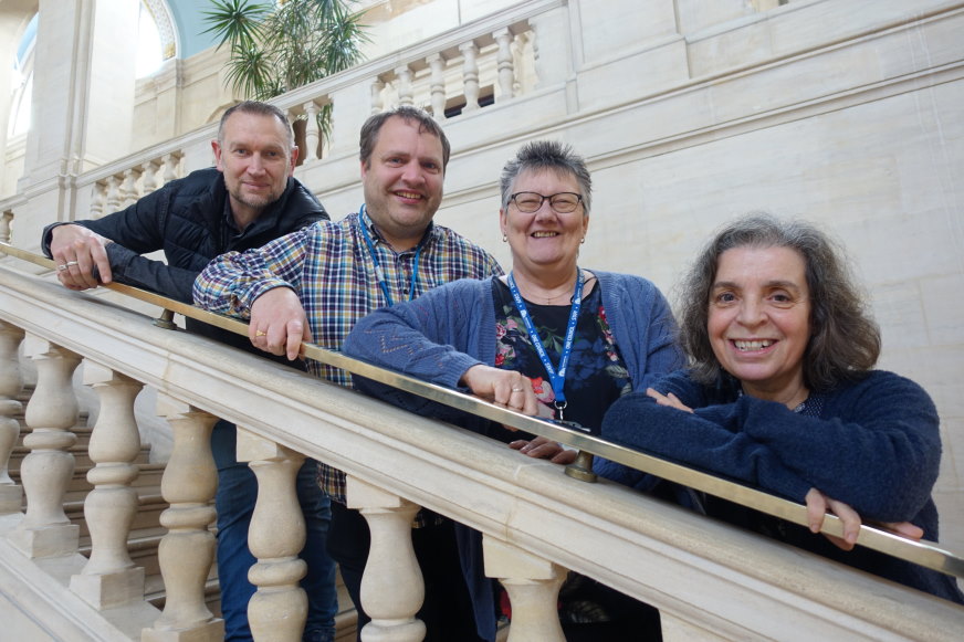 The four members of the Tenant Engagement Team posing on the main staircase of the Civic Centre