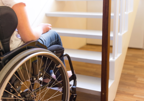 Person in wheelchair at bottom of stairs