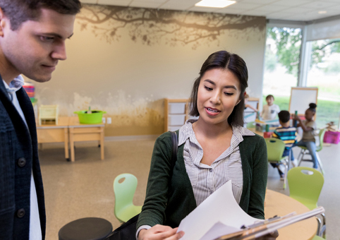 Childcare professional talking to a parent