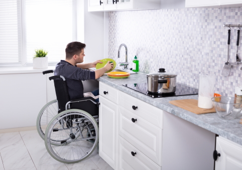 Man in wheelchair in his adapted kitchen
