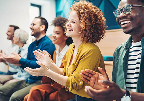 People clapping at a conference