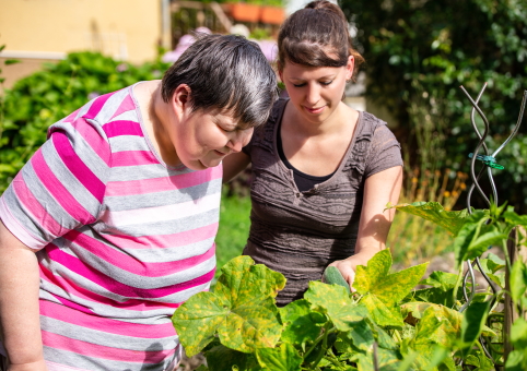 Woman and disabled woman in garden