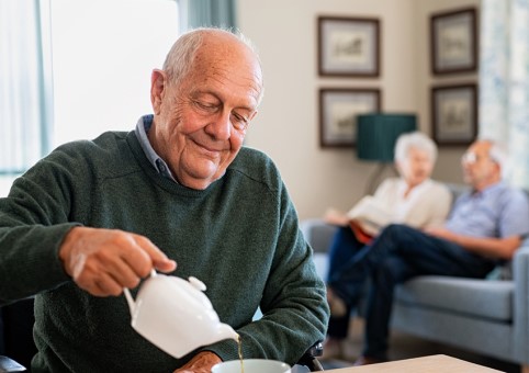 A man pouring tea from a teapot