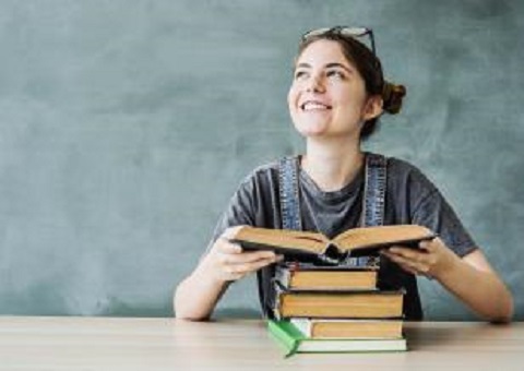 A young woman happily reading a book