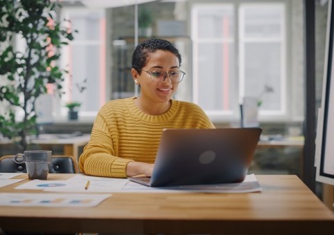 Woman typing at laptop