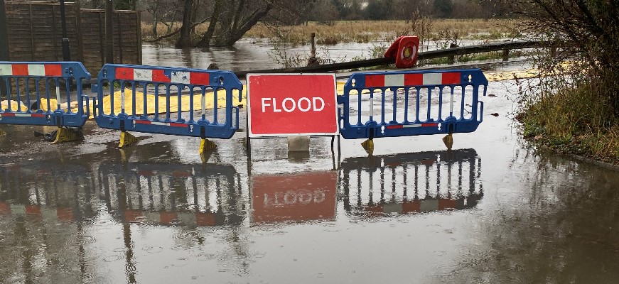 Sign warning of flooding in road