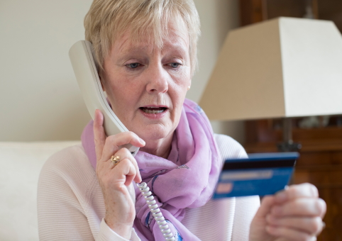 Woman giving bank card details over the phone