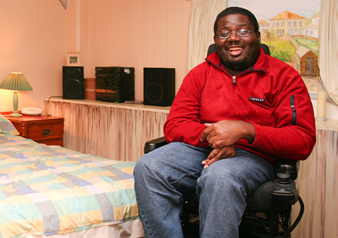 Man in wheelchair in his bedroom