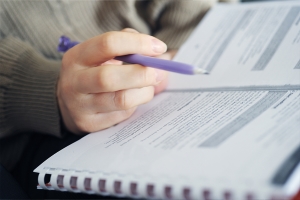 Person making notes in book