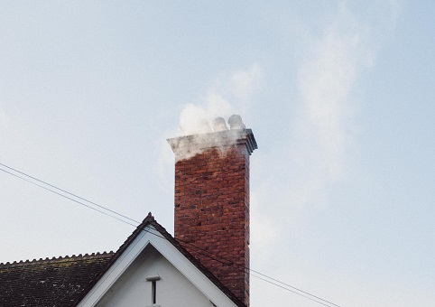 Smoke coming from house chimney