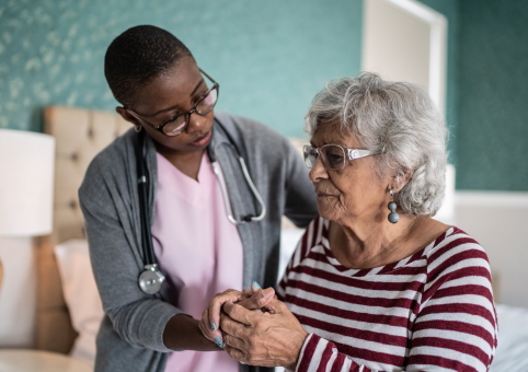 Doctor helping elderly woman