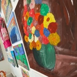 Photo of a painting of colourful flowers in a vase
