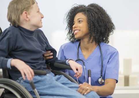 Medical professional with a child in a wheelchair