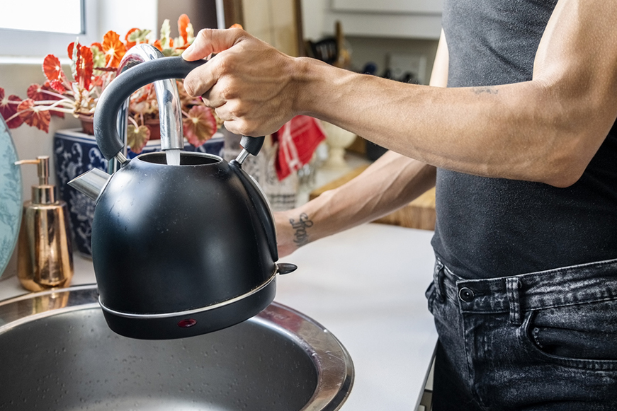 Person Filling Up A Kettle