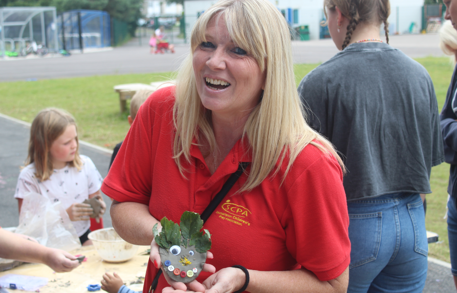 An adult ambassador holding a craft project