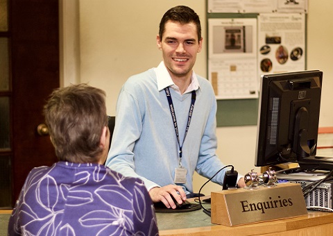 Library worker with customer