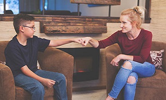 Adult and child doing a fistbump