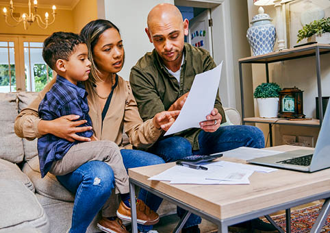 Parents and child looking at a letter