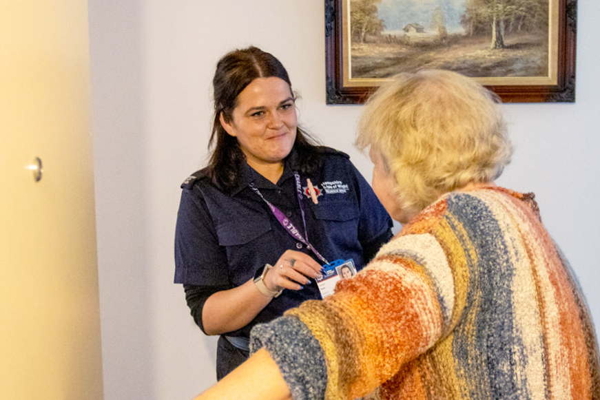 A fire service officer showing her ID to another person A fire service officer showing her ID to another person