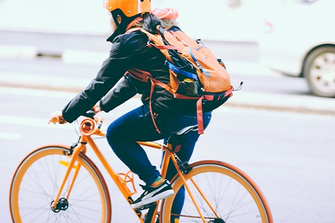 Cyclist on the road wearing safety gear
