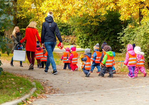 Group of children on a trip in high-vis jackets