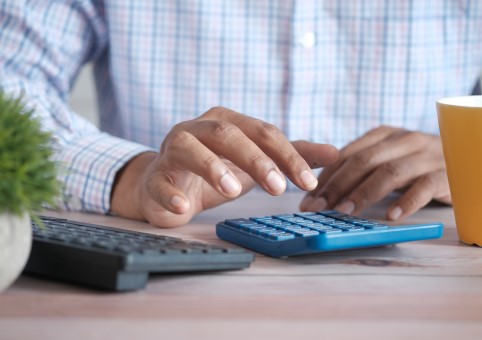 Man using a calculator