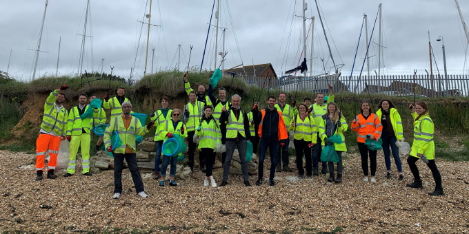 A large group of litter pickers on a beach