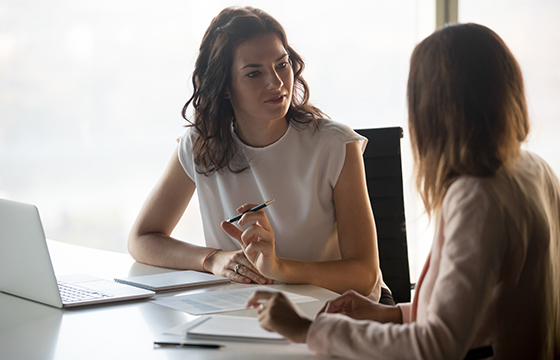 Two women talking at work