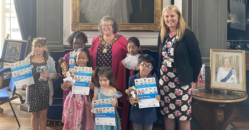 Image of the Right Worshipful Mayor of Southampton, the Children's Mayor, Dr Debbie Chase (Director of Public Health) and the winners of the One Southampton Primary School Drawing Competition