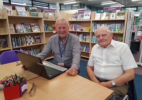 Volunteers at library computer