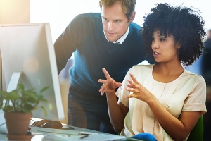 Man and woman in front of computer