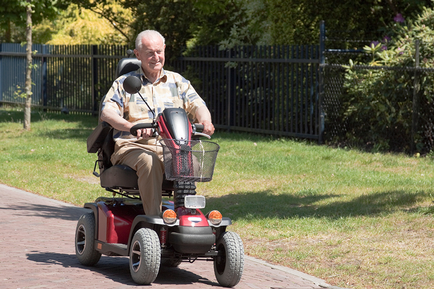 Older Man Riding Mobility Scooter Outdoors