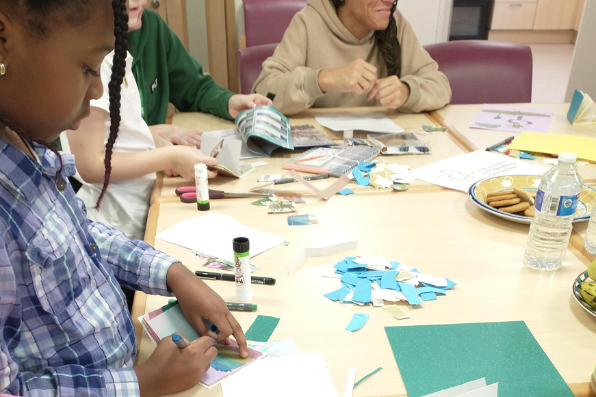 Several people of different ages and ethnicities doing arts and crafts at a table Several people of different ages and ethnicities doing arts and crafts at a table