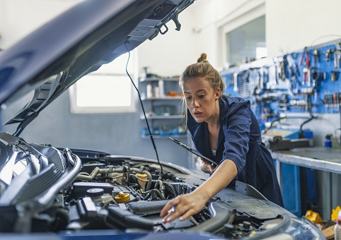 A mechanic working on a car engine