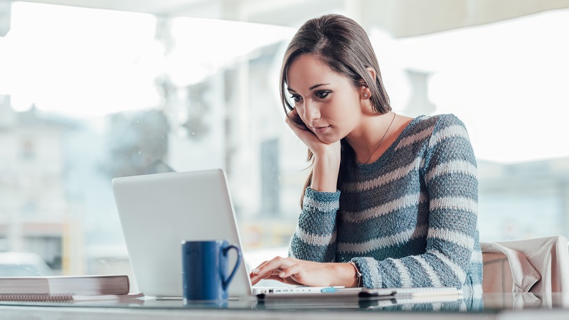 Adopt South woman working on laptop