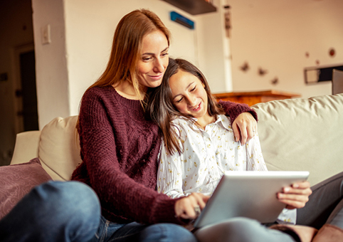 Parent and child looking at a tablet