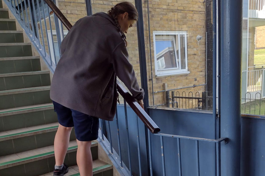A Woman Cleaning A Staircase A Woman Cleaning A Staircase