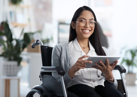 Woman in wheelchair using tablet