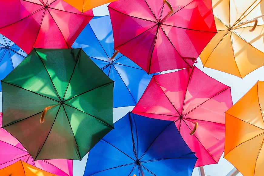 Multicoloured open umbrellas from underneath
