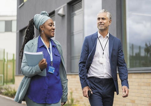 Two school staff walking side by side