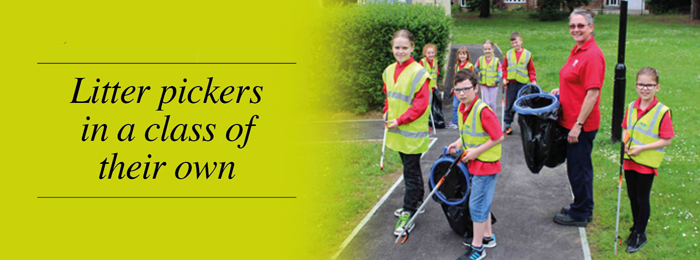 A group of young litter pickers. Text: Litter pickers in a class of their own