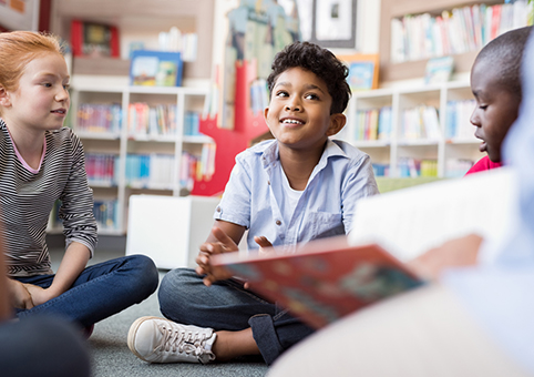 Children sitting on the floor in a library