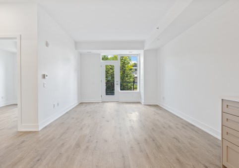 An empty flat with wooden floors and white walls