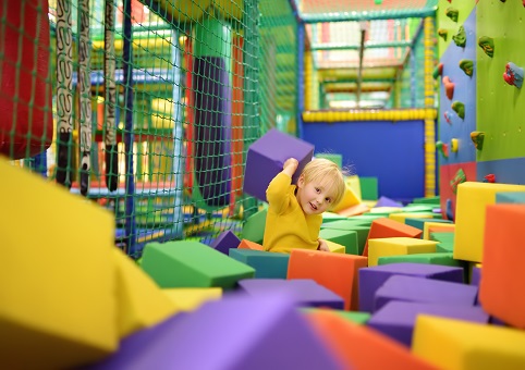 A young child in a foam play pit