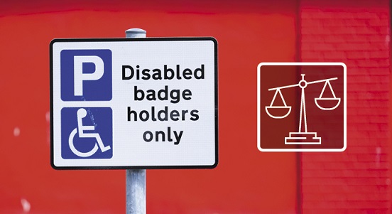 Parking sign saying "Disabled badge holders only" along with the scales of justice