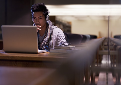 Man sitting at desk on laptop